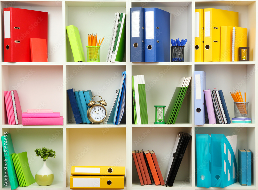 White office shelves with different stationery, close up
