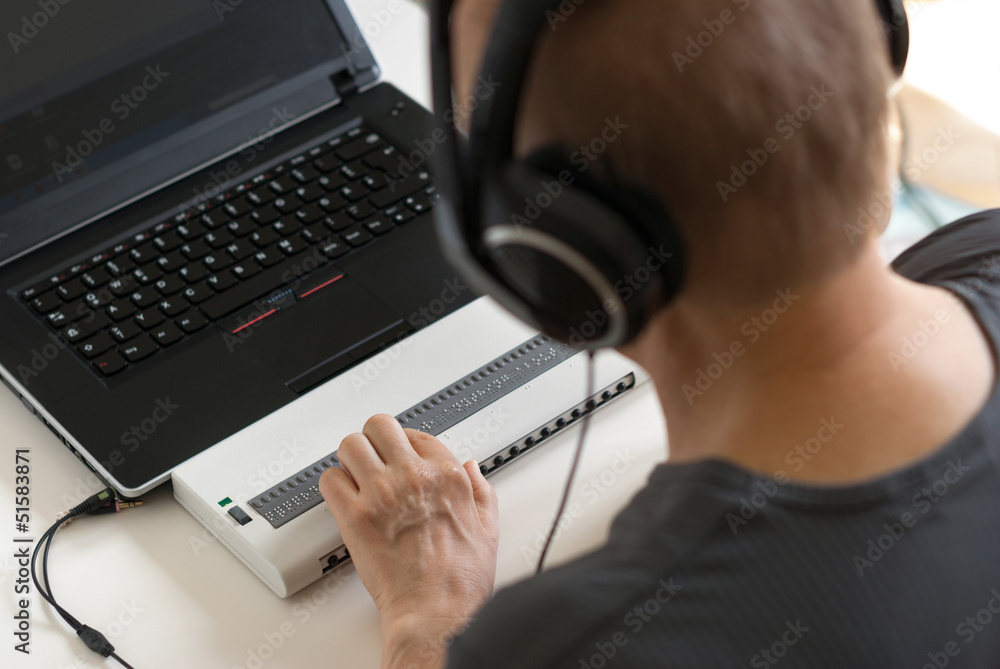 Blind person working on computer with braille display and screen Stock ...