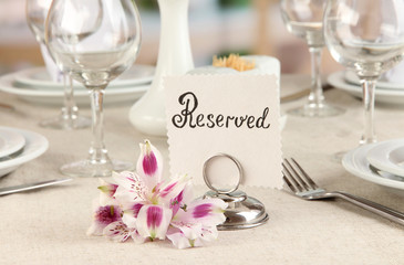 Sticker - Reserved sign on restaurant table with empty dishes and glasses