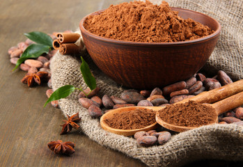 Wall Mural - Cocoa powder and cocoa beans  on wooden background