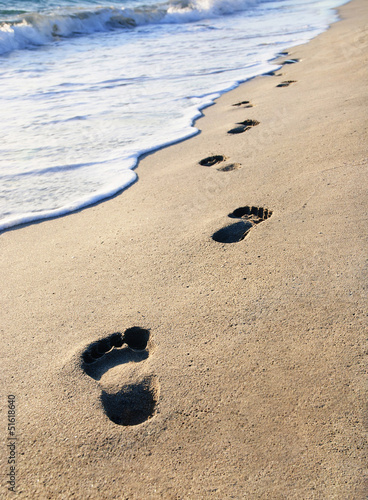 Obraz w ramie beach, wave and footsteps at sunset time