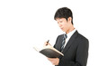 © masa1986 - 手帳を持った男性　驚く