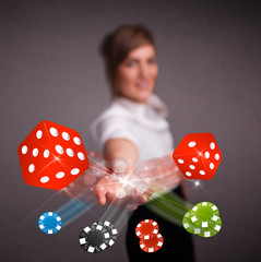 Young woman throwing dices and chips