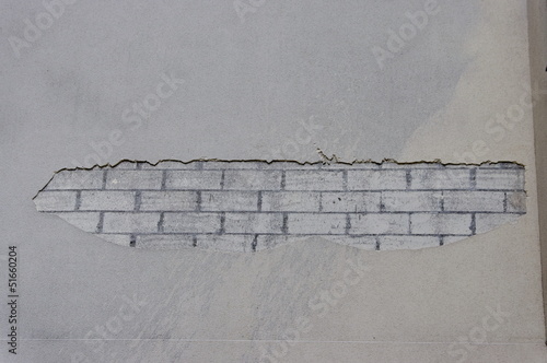 mur abimé : briques apparentes sous l'enduit - Acheter cette photo
