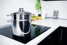 Big pot in modern kitchen with induction stove