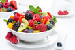 salad of fresh fruit and berries in a white bowl