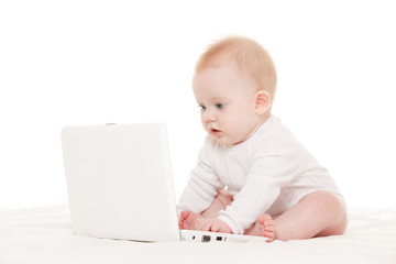 Wall Mural - Cute baby with laptop on the white bed