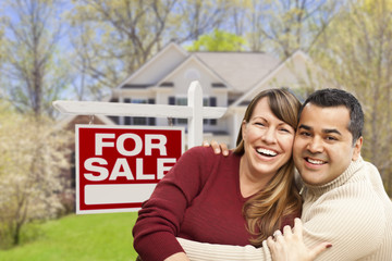 Couple in Front of For Sale Sign and House