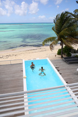 Upper view of couple swimming in infinity pool