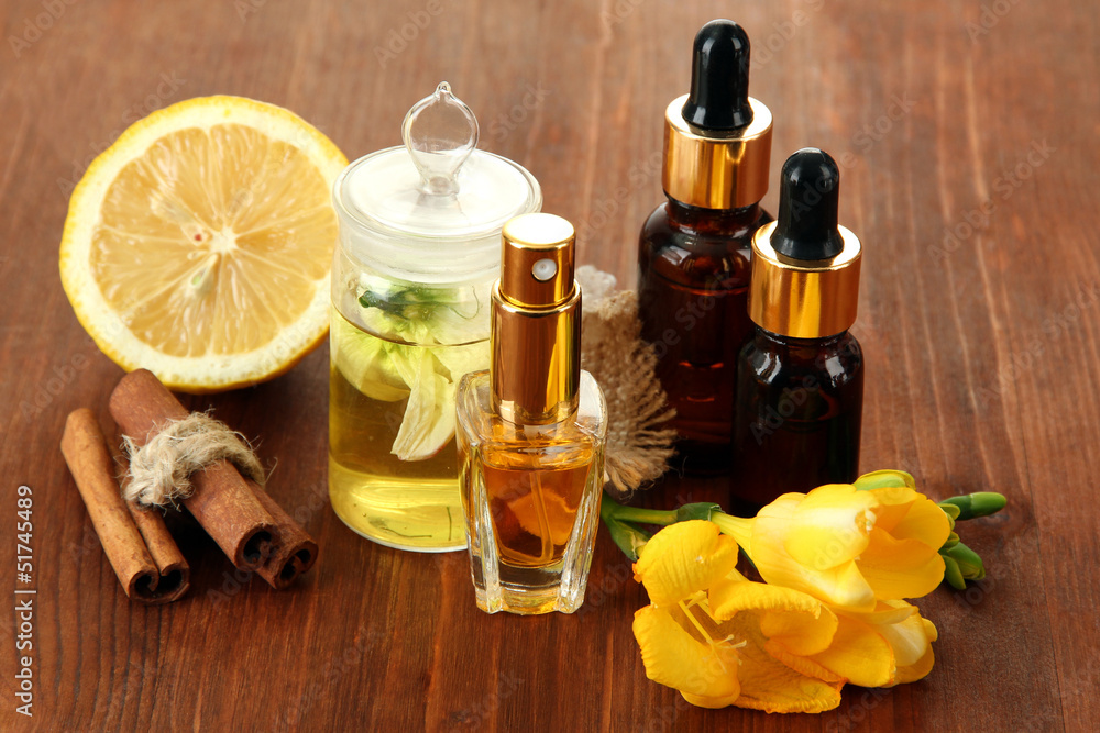 Bottles with ingredients for the perfume on wooden background