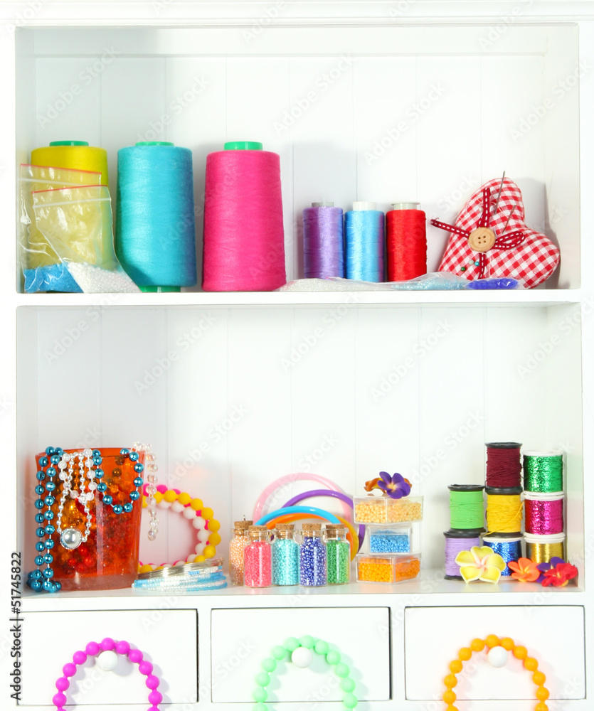 Beautiful white shelves with thread and material for