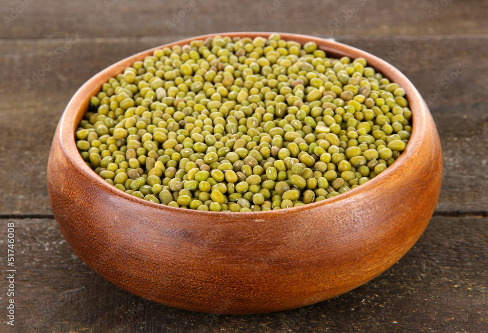 Beans in bowl on wooden background