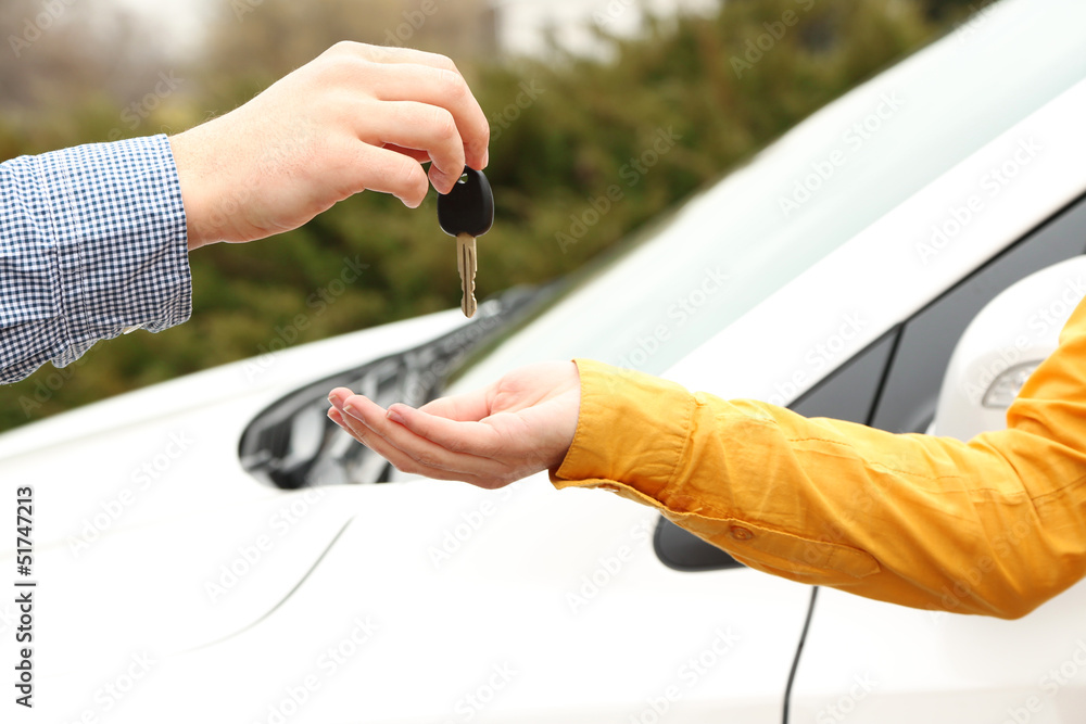Woman and man hands with car key, close up