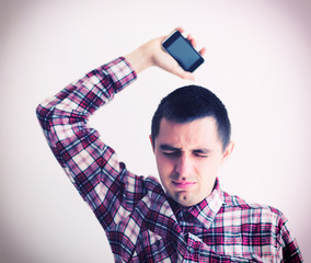 Wall Mural - Angry businessman throwing his mobile phone