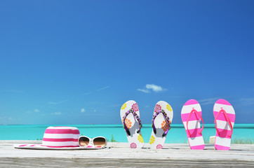 Hat, sunglasses and flip-flops on the beach of Exuma, Bahamas