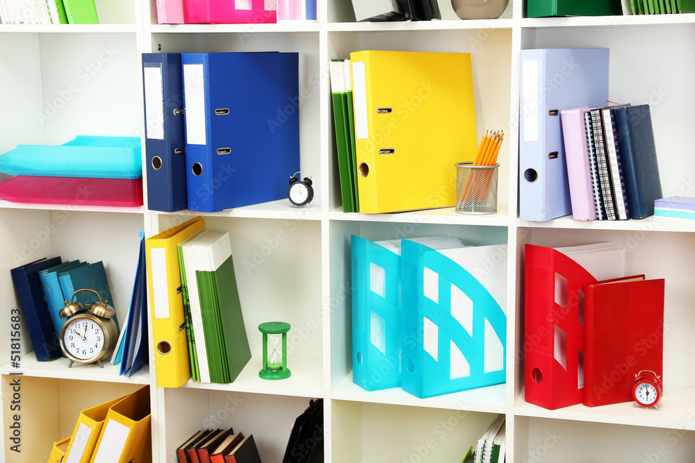White office shelves with different stationery, close up