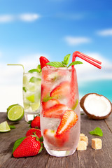 Canvas Print - Fresh summer drink on wooden table with blur sea background