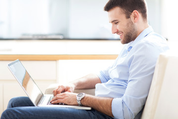 Canvas Print - Man on sofa with laptop