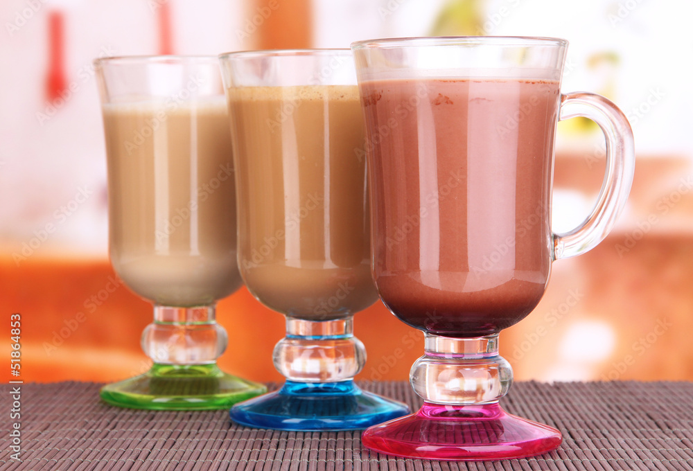 Layered coffee in glass on table on bright background