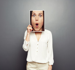 Wall Mural - woman covering image with big amazed face