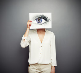 Wall Mural - woman covering image with big eye