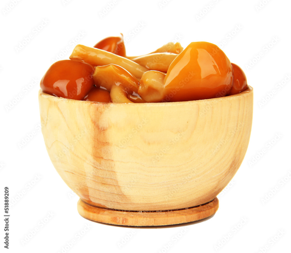 Mushrooms in wooden bowl, isolated on white