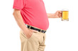 A man with belly holding a beer glass