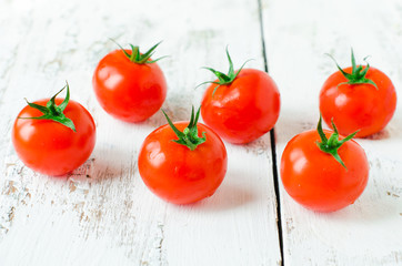 Fresh tomatoes on the wooden background