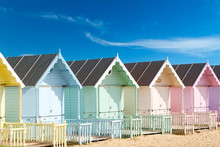 Traditional British Beach Huts On A Bright Sunny Day