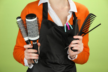 Wall Mural - Hairdresser in uniform with working tools, on color background