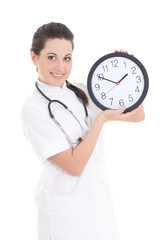 Wall Mural - young beautiful female doctor with clock isolated on white