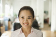 © xixinxing - Young woman smiling in the office, portrait