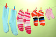 © Africa Studio - Colorful socks hanging on clothesline, on color background