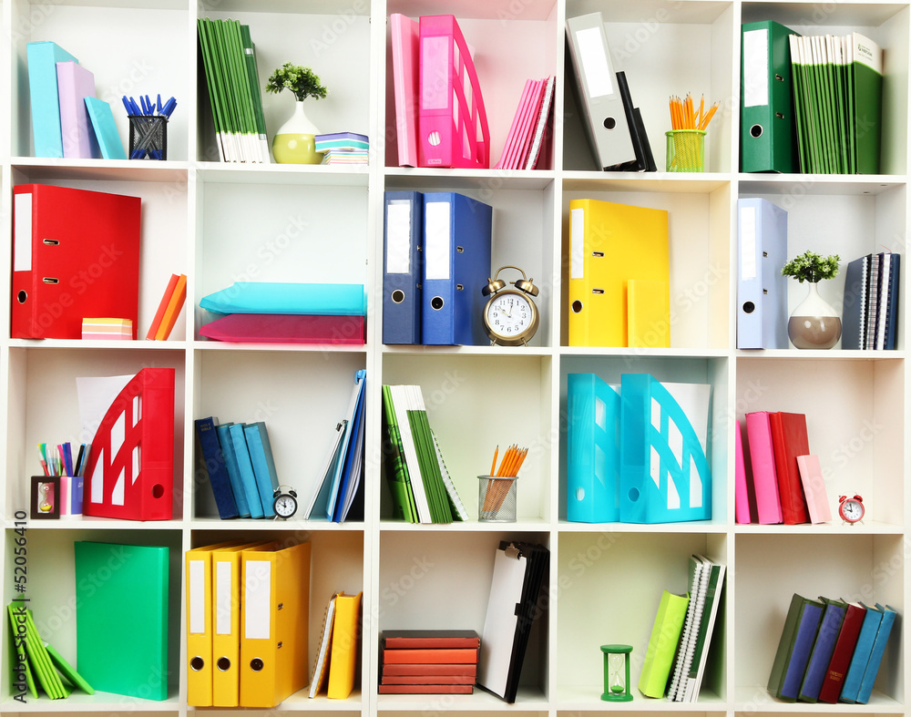 White office shelves with different stationery, close up