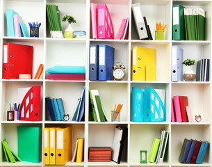 Wall Mural - White office shelves with different stationery, close up