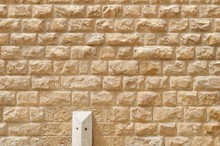 Texture Of The Wall Built Of Rough Yellow Stone Blocks