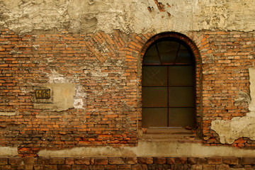 old window on red brick wall