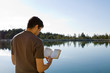 © Balazs - Man Reading Bible By Lake