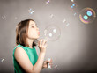 © xavier gallego morel - young girl blowing bubbles