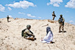 Soldier negotiating with militant in desert