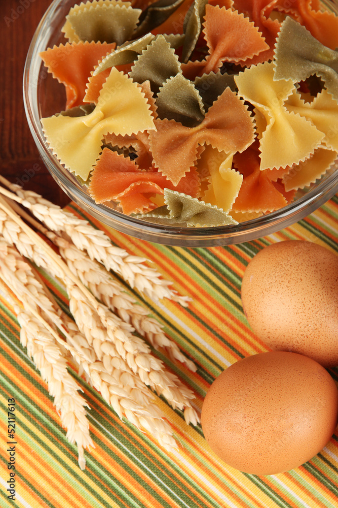 Different types of pasta on striped tablecloth