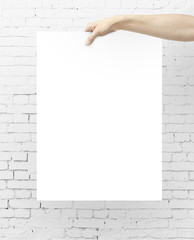 hand holding blank poster