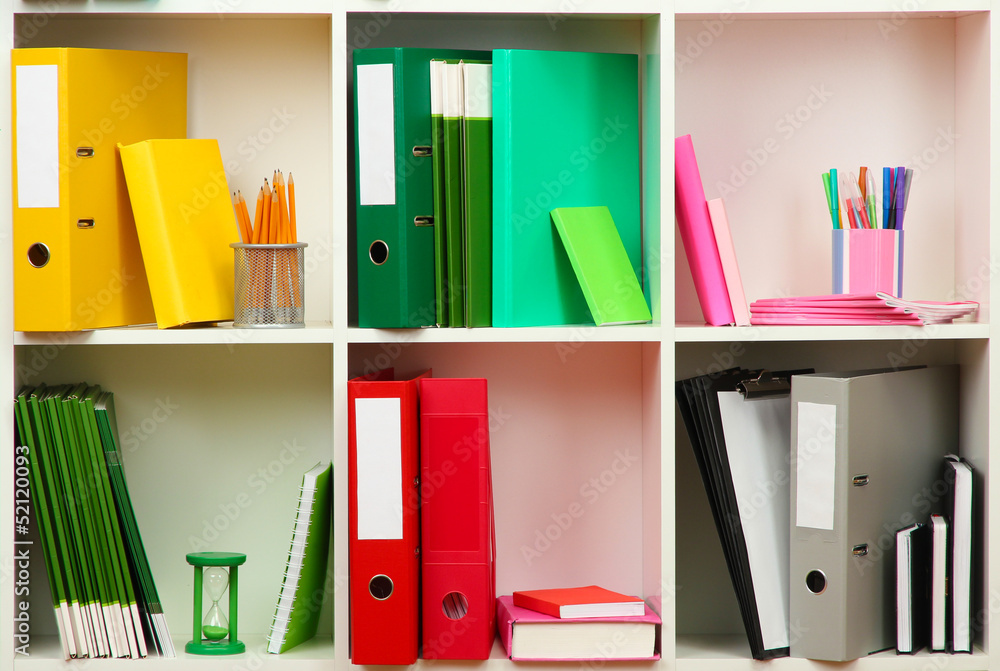 White office shelves with different stationery, close up