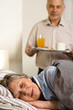 © CandyBox Images - Loving senior husband serving breakfast to wife