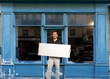 © FrankBoston - Man with sign by shop