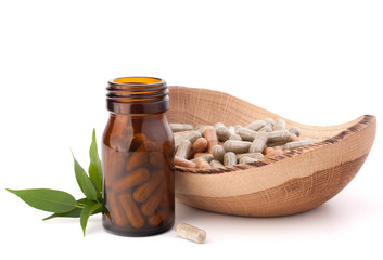 Wall Mural - Herbal drug capsules in brown glass bottle. Alternative medicine