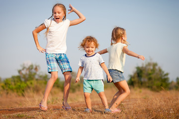 Poster - two little girls and little boy dancing on the road