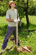 © jinga80 - Young man with a straw hat taking a break after cutting wood.