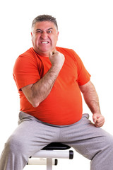 Overweight man showing his strength after doing exercises seted