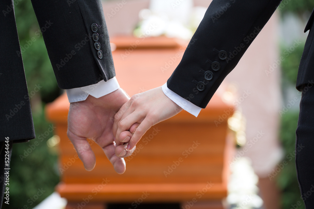People at funeral consoling each other - obrazy, fototapety, plakaty 